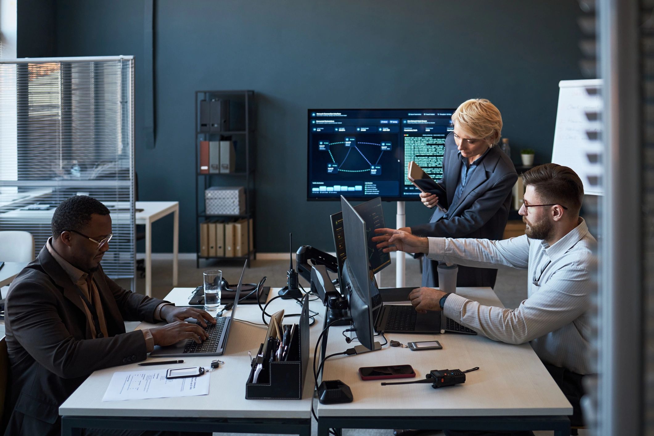 Diverse business team reviewing technology dashboards in office