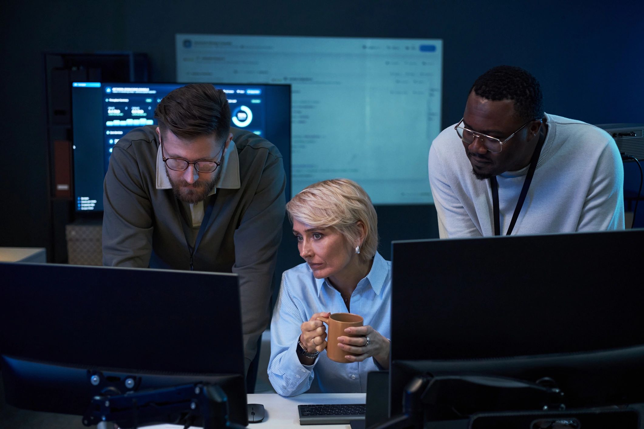 IT team monitoring network operations in a control room