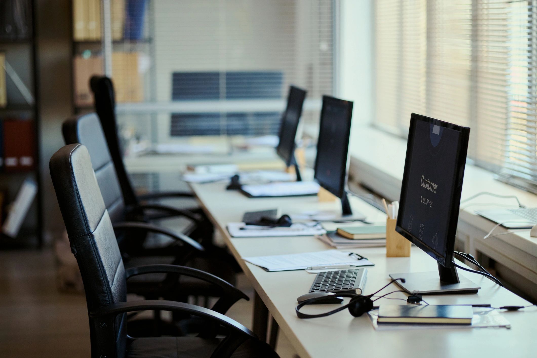 Monitoring workspace with multiple screens for operational oversight