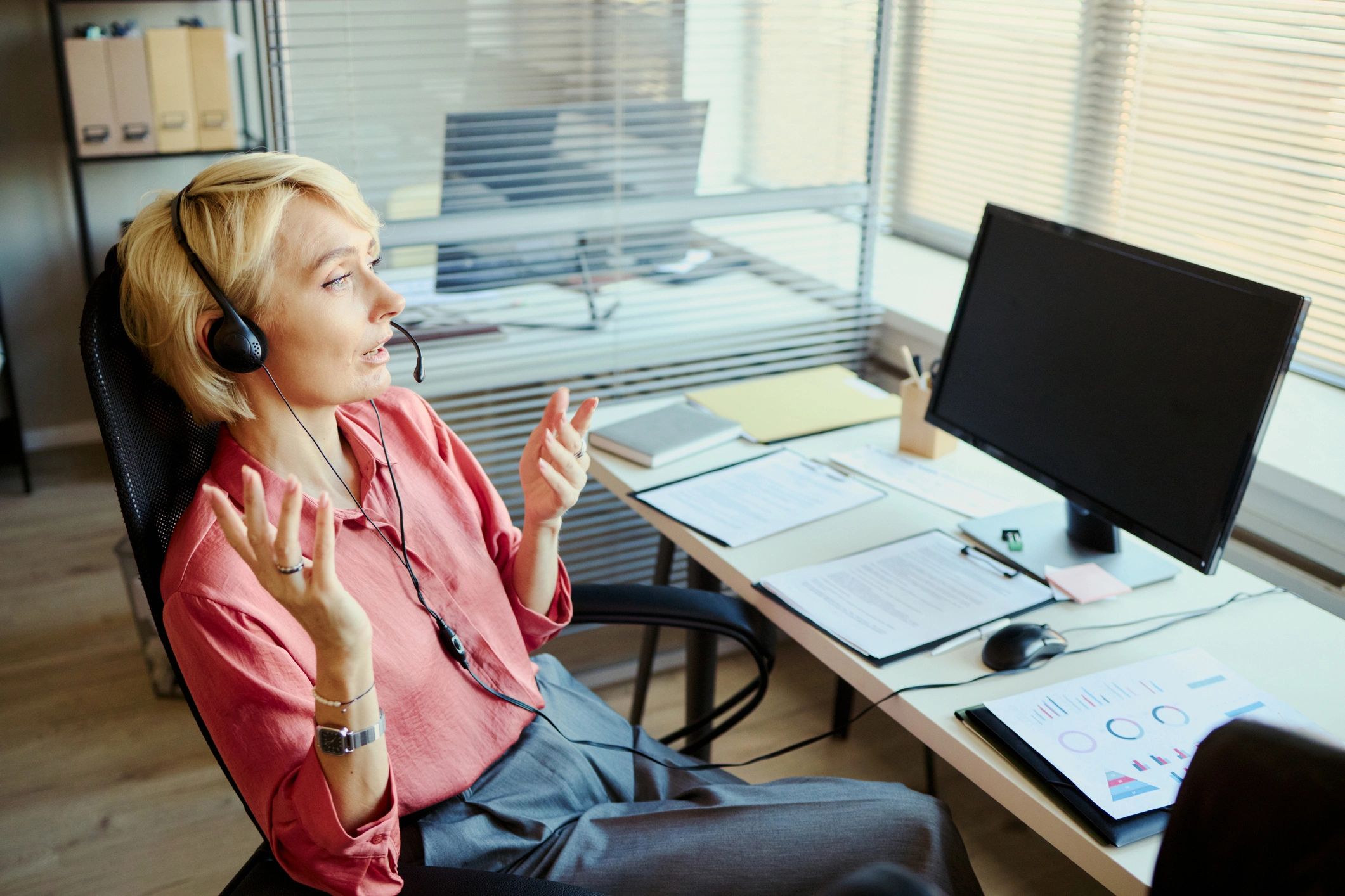 Call center agent speaking in customer support office